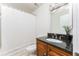 Well-lit bathroom featuring a vanity with granite counters and shower with curtain at 6204 Santa Fe Pkwy, Atlanta, GA 30350