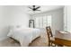 Well-lit bedroom featuring a ceiling fan, window with shutters, and a functional desk setup at 6204 Santa Fe Pkwy, Atlanta, GA 30350