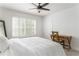 Bright bedroom featuring a ceiling fan, window with shutters, and a functional desk setup at 6204 Santa Fe Pkwy, Atlanta, GA 30350