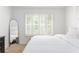 Bright bedroom with plantation shutters, a full-length mirror and neutral decor at 6204 Santa Fe Pkwy, Atlanta, GA 30350