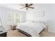 Bright bedroom featuring a ceiling fan, white walls, and a large window with shutter blinds at 6204 Santa Fe Pkwy, Atlanta, GA 30350