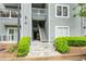 A close up of the exterior of the building with stairs leading to the upper floors and green shrubbery at 6204 Santa Fe Pkwy, Atlanta, GA 30350