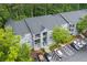 Apartment complex featuring well-maintained gray siding, balconies, ample parking, and surrounded by lush greenery at 6204 Santa Fe Pkwy, Atlanta, GA 30350