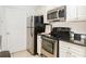 Updated kitchen shows stainless steel oven and microwave with white cabinets and gray countertops at 6204 Santa Fe Pkwy, Atlanta, GA 30350