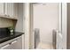 Laundry room with granite counters, dishwasher, and a view of washer-dryer through doorway at 6204 Santa Fe Pkwy, Atlanta, GA 30350