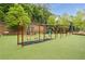 Swinging area with multiple swings, benches and padded ground surrounded by trees in community park at 6204 Santa Fe Pkwy, Atlanta, GA 30350