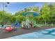 Community playground featuring slides, climbing structures, and a ladybug themed picnic table on a secure padded surface at 6204 Santa Fe Pkwy, Atlanta, GA 30350