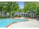 Gorgeous community pool and clubhouse framed by greenery and blue planters at 6204 Santa Fe Pkwy, Atlanta, GA 30350