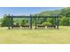 Inviting swing area with shaded benches overlooking a beautiful lake with green trees, and a wooden fence at 6204 Santa Fe Pkwy, Atlanta, GA 30350