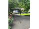 Charming home featuring a covered carport and cozy front porch, surrounded by lush greenery at 167 Mathews Se Cir, Marietta, GA 30067
