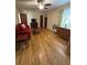 Well-lit living room with hardwood floors, a comfortable red sofa, and stylish furnishings at 167 Mathews Se Cir, Marietta, GA 30067