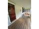 Cozy screened porch with a decorative wreath, bench, and wood flooring, offering a welcoming space at 167 Mathews Se Cir, Marietta, GA 30067