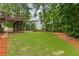 Lush backyard with well-manicured lawn and mature trees, perfect for outdoor enjoyment at 2759 Thomashire Trce, Marietta, GA 30066