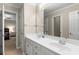 Bright bathroom featuring a double sink vanity with white cabinets and a large mirror at 2759 Thomashire Trce, Marietta, GA 30066