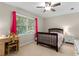 Cozy bedroom with a ceiling fan, a bed, a desk, and natural light streaming through the window at 2759 Thomashire Trce, Marietta, GA 30066