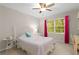 Cozy bedroom with a ceiling fan, natural light, and soft decor at 2759 Thomashire Trce, Marietta, GA 30066