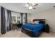 Comfortable bedroom with neutral walls, a fan, a desk, and a bed with blue bedding at 2759 Thomashire Trce, Marietta, GA 30066