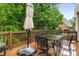 Spacious deck with an umbrella for shade and a picturesque backyard view at 2759 Thomashire Trce, Marietta, GA 30066