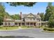 Beautiful two-story home with manicured lawn, mature trees, and charming architectural details at 2759 Thomashire Trce, Marietta, GA 30066