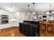 Eat-in kitchen features white cabinetry, stainless steel appliances and a black center island with a cooktop at 2759 Thomashire Trce, Marietta, GA 30066
