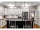 Updated kitchen features stainless steel appliances, granite counters, and central island with seating at 2759 Thomashire Trce, Marietta, GA 30066