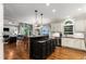 Open concept kitchen features white cabinetry, stainless appliances, and a center island with a cooktop at 2759 Thomashire Trce, Marietta, GA 30066