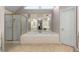 Main bathroom with a glass enclosed shower, soaker tub, and a large mirror at 2759 Thomashire Trce, Marietta, GA 30066