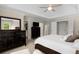 Primary bedroom featuring dark wood furnishings, a ceiling fan, and ample closet space at 2759 Thomashire Trce, Marietta, GA 30066