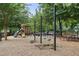 Community playground with swings, slide, picnic table, and soft ground covering at 2759 Thomashire Trce, Marietta, GA 30066