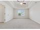 Spacious bedroom with a tray ceiling, fan, and large window providing ample natural light at 3182 Hartford Mill Pl, Duluth, GA 30097