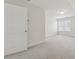 Bedroom with carpet flooring, a window, and a door, with neutral paint and trim at 3182 Hartford Mill Pl, Duluth, GA 30097