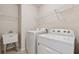 Functional laundry room with washer, dryer, and utility sink for added convenience at 3182 Hartford Mill Pl, Duluth, GA 30097