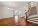Spacious living area featuring hardwood floors and staircase leading to the upper level at 3182 Hartford Mill Pl, Duluth, GA 30097