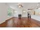 Open floor plan with a fireplace, hardwood floors, and a view to the kitchen at 3182 Hartford Mill Pl, Duluth, GA 30097