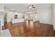 Open floor plan with a fireplace, hardwood floors, and a view to the kitchen at 3182 Hartford Mill Pl, Duluth, GA 30097