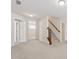 Open living room with carpet flooring, a staircase, and neutral paint for a bright and inviting feel at 3182 Hartford Mill Pl, Duluth, GA 30097