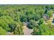 Aerial view of house nestled in lush green neighborhood with mature trees at 804 Rose Creek Walk, Woodstock, GA 30189