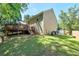 Expansive backyard with lush green grass, wooden deck and two-story home at 804 Rose Creek Walk, Woodstock, GA 30189