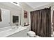 Bathroom with a white vanity, toilet and a shower with a brown and white polka dot shower curtain at 804 Rose Creek Walk, Woodstock, GA 30189