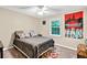 Neutral bedroom features a ceiling fan, window, and fun Star Wars decor at 804 Rose Creek Walk, Woodstock, GA 30189