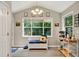 Bright breakfast nook with large windows, sunflower decor, and a cozy bench with storage at 804 Rose Creek Walk, Woodstock, GA 30189