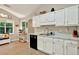 Bright kitchen with stainless steel sink, white cabinets, and a cozy breakfast nook at 804 Rose Creek Walk, Woodstock, GA 30189