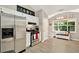 Modern kitchen with stainless steel appliances and ample counter space, adjacent to a bright and sunny breakfast nook at 804 Rose Creek Walk, Woodstock, GA 30189