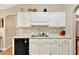 Kitchen featuring white cabinets, marble countertops, stainless steel sink and black appliances at 804 Rose Creek Walk, Woodstock, GA 30189