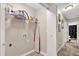 Functional laundry room space has an ironing board, shelving, and neutral paint at 804 Rose Creek Walk, Woodstock, GA 30189