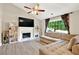 Cozy living room boasts a fireplace, large windows, and built-in bookshelves, creating a comfortable and stylish atmosphere at 804 Rose Creek Walk, Woodstock, GA 30189