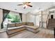 Bright living room with large windows, hardwood floors, and a comfortable seating area, perfect for relaxation and entertainment at 804 Rose Creek Walk, Woodstock, GA 30189