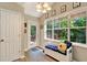 Bright sunroom with large windows, cozy seating, and access to the outdoor deck, creating a relaxing and inviting space at 804 Rose Creek Walk, Woodstock, GA 30189