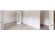 Bedroom with white trim, light wood floors, and an open closet space for organized storage solutions at 900 Ellesmere Pt, Mcdonough, GA 30253