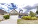 Charming home featuring a stone facade, white garage door, well-manicured lawn, and inviting blue front door at 900 Ellesmere Pt, Mcdonough, GA 30253